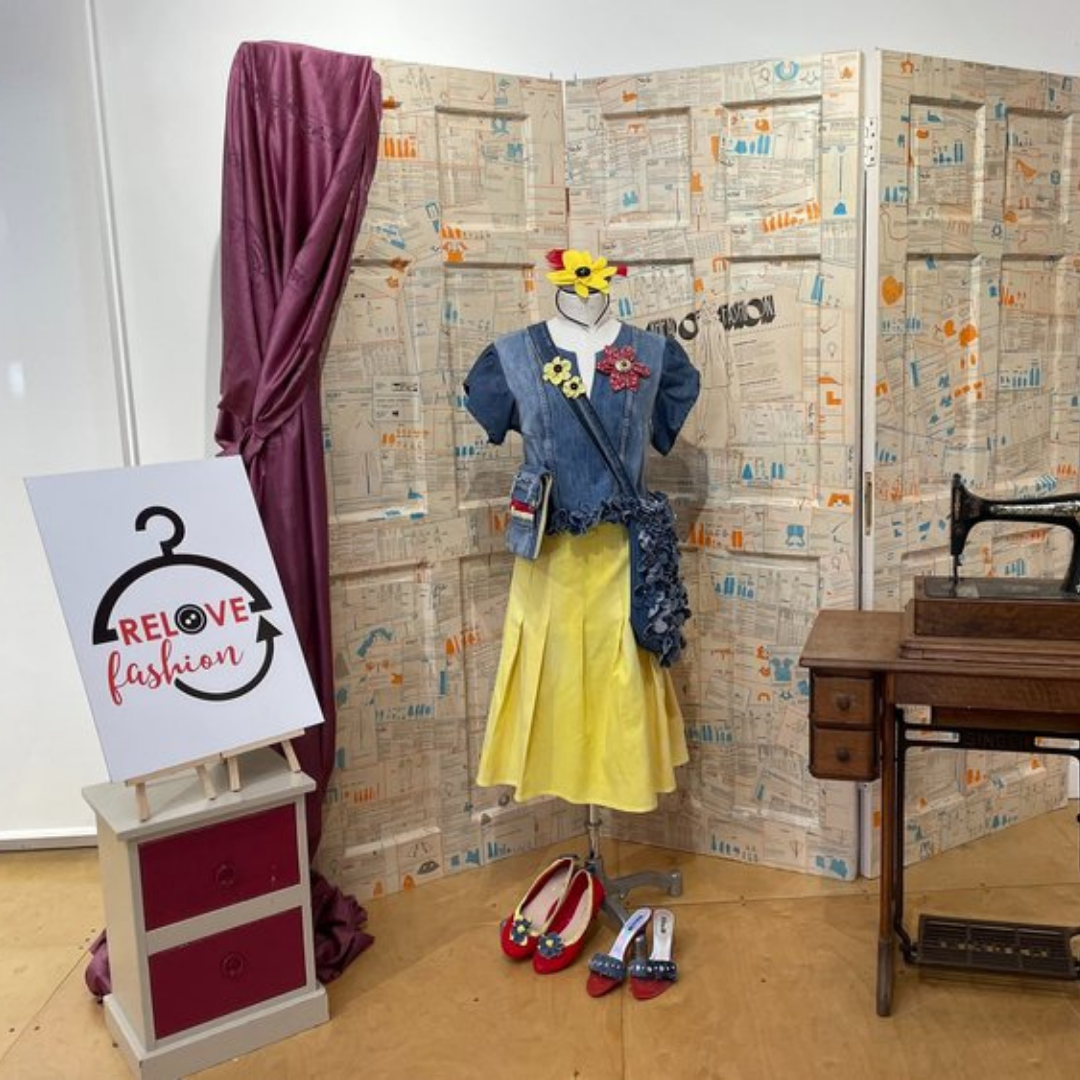 Relove Fashion 2022 Winner outfit on mannequin, outfit includes denim top and yellow knee length skirt